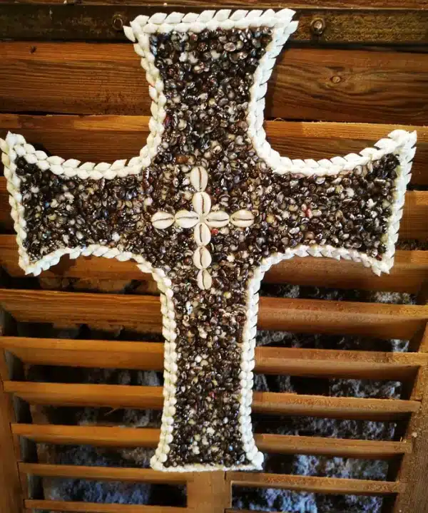 Croix artisanale de Bali en coquillages noirs, blancs et cauris crème.